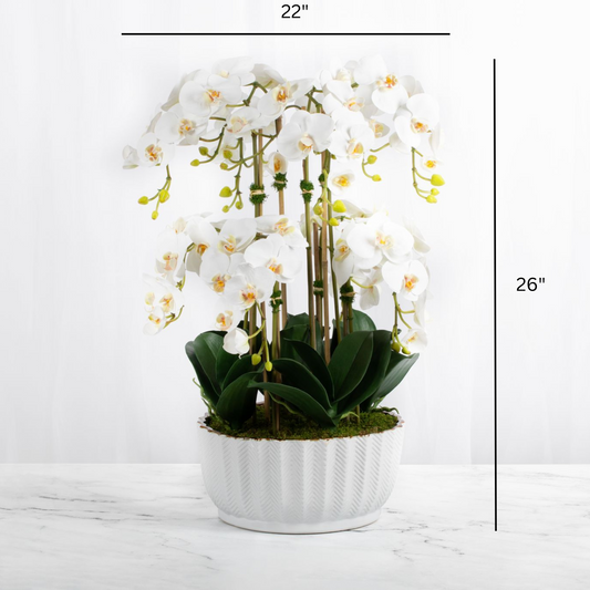 Faux orchid centerpiece in white vase