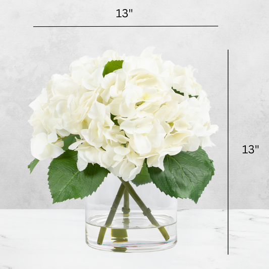 Faux hydrangea centerpiece arrangement in glass vase