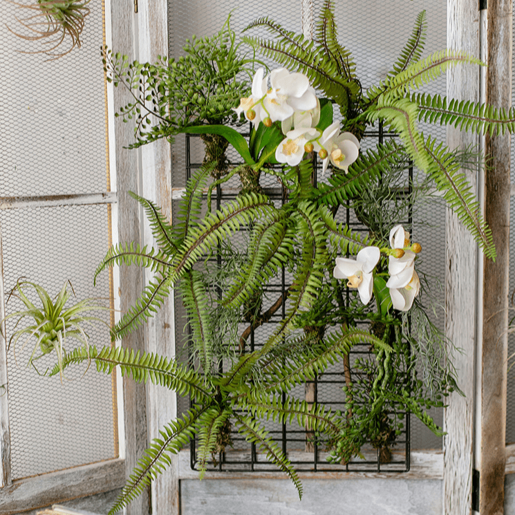 Decorazione da parete con pianta artificiale e cornice in metallo