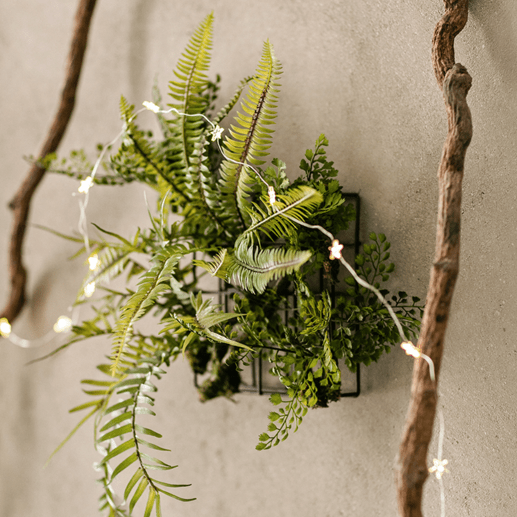 Decorazione da parete con pianta artificiale e cornice in metallo