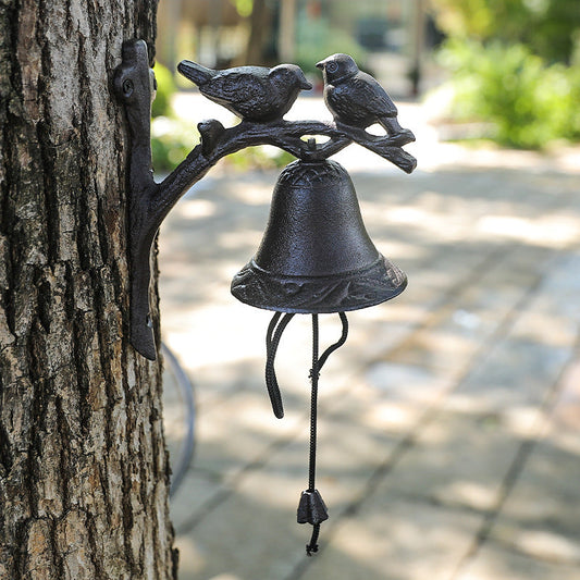 Cloche en fonte à deux oiseaux